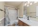 Well-lit bathroom with a shower-tub combo and a vanity with neutral countertop at 11026 Clearspring Way, Indianapolis, IN 46239