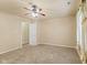 Bedroom with neutral carpet, walls, ceiling fan and a door to a walk in closet at 11026 Clearspring Way, Indianapolis, IN 46239