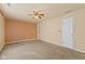Neutral-toned carpeted bedroom with a ceiling fan, closet, and ample natural light at 11026 Clearspring Way, Indianapolis, IN 46239