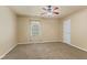 Cozy carpeted bedroom with a ceiling fan and window, offering a relaxing retreat at 11026 Clearspring Way, Indianapolis, IN 46239