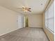 Bedroom with neutral carpet, window, and ceiling fan. Adjacent rooms add convenience at 11026 Clearspring Way, Indianapolis, IN 46239
