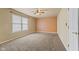 Spacious carpeted bedroom with neutral walls, a ceiling fan, and a bright window at 11026 Clearspring Way, Indianapolis, IN 46239