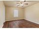 Cozy bedroom featuring wood flooring, a ceiling fan, and a bright window at 11026 Clearspring Way, Indianapolis, IN 46239