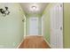 Inviting entryway with light green walls, wood flooring, and white doors at 11026 Clearspring Way, Indianapolis, IN 46239