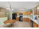 Efficient kitchen featuring wood cabinets, black appliances, and plenty of counter space for meal preparation at 11026 Clearspring Way, Indianapolis, IN 46239