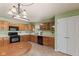 Bright kitchen offering ample cabinet space, black appliances, and a charming chandelier at 11026 Clearspring Way, Indianapolis, IN 46239