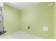 Functional laundry room with green walls and tile flooring at 11026 Clearspring Way, Indianapolis, IN 46239