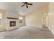 Inviting living room showcasing a classic white brick fireplace, neutral walls, and plush carpeting at 11026 Clearspring Way, Indianapolis, IN 46239
