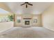 Spacious living room featuring a cozy fireplace with a white brick surround and neutral carpeting at 11026 Clearspring Way, Indianapolis, IN 46239