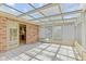 Well-lit sunroom with tiled floors and glass ceiling, connected to the kitchen and backyard at 11026 Clearspring Way, Indianapolis, IN 46239