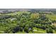 The expansive lot shows the home nestled amongst mature trees and green landscape at 11603 Maze Rd, Indianapolis, IN 46259