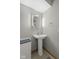 Cozy powder room with stylish pedestal sink and oval mirror at 11603 Maze Rd, Indianapolis, IN 46259