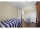 Bright bedroom with wood floors, neutral walls, and ample closet space at 11603 Maze Rd, Indianapolis, IN 46259