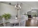 Bright dining room with an elegant chandelier, natural light, and hardwood floors at 11603 Maze Rd, Indianapolis, IN 46259