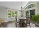 Cozy dining room with dark floors, an elegant chandelier, and picturesque backyard views at 11603 Maze Rd, Indianapolis, IN 46259