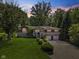 Charming two-story home with a lush green lawn and manicured landscaping at 11603 Maze Rd, Indianapolis, IN 46259