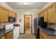 Kitchen with oak cabinets, black refrigerator and white stove at 11603 Maze Rd, Indianapolis, IN 46259