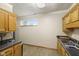 Kitchen featuring oak cabinets, black countertops and wood flooring at 11603 Maze Rd, Indianapolis, IN 46259