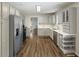 Kitchen with stainless steel appliances and new wood floors at 11603 Maze Rd, Indianapolis, IN 46259