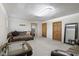 Living room showcasing carpet, a leather sofa and a wooden door at 11603 Maze Rd, Indianapolis, IN 46259