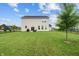 Large, grassy backyard with black fence, perfect for recreation and relaxation, with a covered patio area at 11809 Redpoll Trl, Noblesville, IN 46060