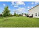 Lush backyard features a well-manicured lawn, mature trees, and ample space for outdoor lounging and entertaining at 11809 Redpoll Trl, Noblesville, IN 46060