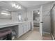 Bathroom with white cabinets and a vanity, plus a view of the bedroom at 11809 Redpoll Trl, Noblesville, IN 46060