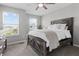 Charming bedroom features a rustic wood bed frame, neutral walls, two large windows and plush carpet at 11809 Redpoll Trl, Noblesville, IN 46060