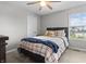 Cozy bedroom with a double bed, neutral walls, plush carpet, and a window view at 11809 Redpoll Trl, Noblesville, IN 46060
