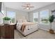 Bright bedroom featuring a neutral color palette, plush carpet, and three large windows with neighborhood views at 11809 Redpoll Trl, Noblesville, IN 46060