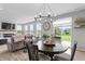 Inviting dining area with modern chandelier and view to the backyard at 11809 Redpoll Trl, Noblesville, IN 46060