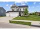 Two story home with three car garage and well manicured lawn on a sunny day at 11809 Redpoll Trl, Noblesville, IN 46060