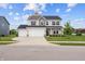 Two story home with three car garage and well manicured lawn on a sunny day at 11809 Redpoll Trl, Noblesville, IN 46060