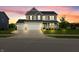 Two story home with three car garage and well manicured lawn at sunset at 11809 Redpoll Trl, Noblesville, IN 46060
