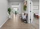 Inviting foyer featuring wood floors, decorative accents, and seamless transition to the dining area at 11809 Redpoll Trl, Noblesville, IN 46060