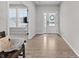 Bright foyer with wood floors, white front door, and views into other rooms at 11809 Redpoll Trl, Noblesville, IN 46060