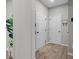 Hallway with multiple doors and neutral walls, plus a plant in the corner at 11809 Redpoll Trl, Noblesville, IN 46060