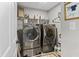 Well-lit laundry room featuring modern LG washer and dryer set and ample storage space on shelving at 11809 Redpoll Trl, Noblesville, IN 46060