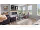Comfortable living room featuring a fireplace, large windows, and ample seating at 11809 Redpoll Trl, Noblesville, IN 46060