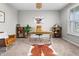 Cozy home office with a wooden desk, comfortable chair, and natural light from the window at 11809 Redpoll Trl, Noblesville, IN 46060