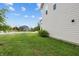 Side yard featuring green grass and sidewalk with view of neighborhood at 11809 Redpoll Trl, Noblesville, IN 46060