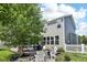 Charming backyard with patio, seating, lush greenery, and a well-maintained lawn area at 123 Bentree Blvd, Danville, IN 46122