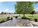 Paver patio with beautiful landscaping, white fence and fire pit, perfect for outdoor entertaining at 123 Bentree Blvd, Danville, IN 46122