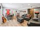 Open basement area offering versatile space with gray couches, decor and light wood flooring at 123 Bentree Blvd, Danville, IN 46122