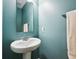 This is a cute and simple bathroom with light blue walls and a pedestal sink at 123 Bentree Blvd, Danville, IN 46122
