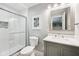 Bright bathroom featuring tiled shower with glass door, vanity, and well-lit mirror at 123 Bentree Blvd, Danville, IN 46122