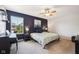 A cozy bedroom illuminated by a ceiling fan, natural light from the window, and bedside lamps at 123 Bentree Blvd, Danville, IN 46122