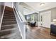 Spacious entryway featuring hardwood flooring, staircase, and view into the front living room at 123 Bentree Blvd, Danville, IN 46122