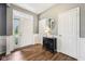 Inviting foyer with hardwood floors, neutral paint, and classic wainscoting detail at 123 Bentree Blvd, Danville, IN 46122