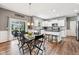 Bright kitchen and dining area with white cabinets, hardwood flooring, and sliding door access to patio at 123 Bentree Blvd, Danville, IN 46122